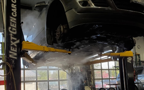 Next Gen Car Care service team performing rust proofing service at their shop in Clinton, NY.